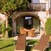 Hazienda Apartmenthotel in Gernsbach: courtyard garden with lounge chairs, table and arched patio doors