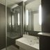 ibis London Thurrock M25 bathroom with glass shower enclosure, sink and illuminated mirror in Grays