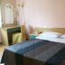 Hotel La Rosta in Reggio nell'Emilia guest room with double bed, desk, chair and mirror