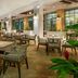 The Westin Playa Bonita Panama outdoor terrace dining area with wicker tables and chairs in Playa Bonita Village