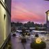 Hotel Borgo Brianteo in Ponte San Pietro courtyard at sunset with outdoor seating and glowing orb lights