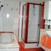 Jaegerstube in Görgeshausen bathroom with shower, bidet, sink and orange towel accents