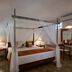 Habarana Village by Cinnamon bedroom with four-poster canopy bed, bedside lamps and dresser in Habarana