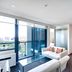 City Tempo Melbourne apartment with floor-to-ceiling windows, city views, sofa and kitchenette