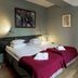 Reimersholme Hotel, Stockholm room with twin beds, red throws and wall art
