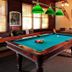 The Historic Crags Lodge in Estes Park game room with pool table and green pendant lights