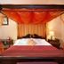 Hostellerie Les Hauts De Sainte Maure bedroom with four-poster bed in Sainte-Maure-de-Touraine