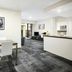 Quest Narre Warren lobby dining area with table, chairs and reception desk in Narre Warren