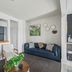 Waters View Inn South Haven guest lounge with navy sofa, two chairs, and wall art