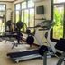 Hotel Buddha International gym in Bodh Gaya with treadmill, weights, bench press and large windows