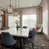 Hilton Garden Inn Riverhead meeting room with fireplace, large table, chairs, and floor-to-ceiling windows