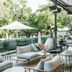 Crystalbrook Byron in Byron Bay outdoor terrace lounge beside pool with cushioned seating and umbrellas