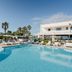 Canne Bianche Lifestyle Hotel in Torre Canne with a large outdoor pool and palm-lined sun loungers