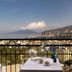 Hotel Cristina in Sorrento with balcony table overlooking sea, town, and distant mountains