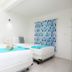 Hotel Maria de Lourdes, Cancún: bright guest room with two white beds and blue accents