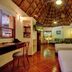 Riviera Maya Suites in Playa del Carmen, thatched-roof suite with two beds, desk and sitting area