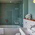 Hotel du Vin Brighton bathroom with mosaic-tiled bathtub, glass shower screen, and sink in Brighton