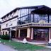 San Remo Palace Hotel in Villa Gesell exterior with glass-front entrance and corner facade