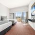 Hope Harbour Hotel in Hope Island with twin beds, balcony doors and marina view