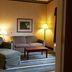 Hampton Inn & Suites Scottsburg guest lounge with sofa, armchair, ottoman and coffee table