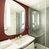 ibis Paris Gare de Lyon Ledru Rollin 12ème bathroom with sink, large mirror and glass shower in Paris
