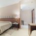 Il Cantagalli, Lamezia Terme: bright hotel room with bed, nightstands, wall lights, and desk
