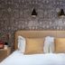 Cotswold Plough Hotel & Restaurant in Bampton bedroom with patterned wallpaper and twin bedside lamps