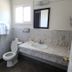 North Coast Inn in Crescent City bathroom with toilet, sink vanity, window, and mirror