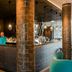 Motel One München-Westend bar area in Munich with tiled columns and a modern illuminated counter