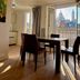 Villa Montmartre in Paris dining area with open balcony doors and Sacré-Cœur view
