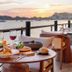 Villa del Palmar Beach Resort Cabo San Lucas dining table with wine and ocean sunset views in Cabo San Lucas