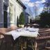 The Old Railway Station, Petworth: outdoor table set with wicker chairs beside the hotel building