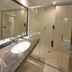Xinji Garden Hotel in Nanchang bathroom with marble vanity, sink, mirror and glass walk-in shower