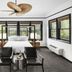 Gaige House in Glen Ellen bedroom with king bed, black chairs, and large windows overlooking greenery