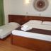 Azzurro Di Boracay Resort in Boracay with a bed, daybed, and green curtains in a simple guest room