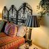 Ann Arbor Bed and Breakfast in Ann Arbor, ornate wrought-iron headboard and patterned bedspread in guest room
