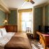Ekesparre Boutique Hotel Kuressaare room with double bed, TV, window seat and patterned carpet