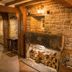 The Manor House Hotel, Dronfield: rustic stone fireplace with stacked logs and warm wood beams