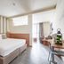 Hotel Borgo Brianteo room in Ponte San Pietro with king bed, seating area, and large window
