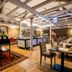 Schlosshotel Weyberhöfe in Sailauf: rustic dining room with set tables, exposed beams and brick walls