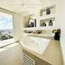 Hotel Stadium León bathroom with soaking tub and floor-to-ceiling window view over the city
