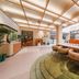Orange Hotel Beijing Tianning Temple lobby with orange seating, plants and skylit ceiling in Beijing