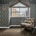 Hotel Porton De La Cabrera in Bogotá: patterned lounge with window seat overlooking city buildings
