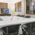 The Wellington Apartment Hotel Brisbane meeting room with conference table, chairs, and TV