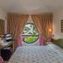 Hotel Kyrton in Forte dei Marmi guest room with round window and garden view