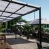 Åsby Hotell in Hallstahammar with a lakeside patio, umbrellas, and outdoor seating under a covered terrace