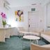 Hotel Zaragoza Plaza in San Sebastian lobby with seating, tables, orchid arrangement and abstract wall art