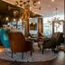 Motel One München-Westend lounge in Munich with modern chairs, brick columns and pendant lighting