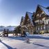 Silverton in Białka Tatrzańska, snowy alpine lodge exterior with steep A-frame roofs and stone base