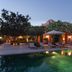 Le Jardin Des Douars in Essaouira with a lit poolside terrace and lounge chairs at dusk